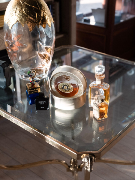 Image may contain Furniture Table Tabletop Bottle Cosmetics Perfume and Tape